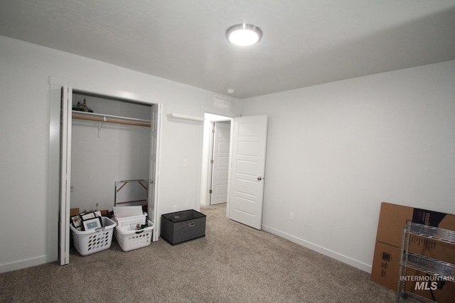 bedroom with carpet, baseboards, and a closet