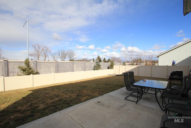 view of patio with outdoor dining space and a fenced backyard