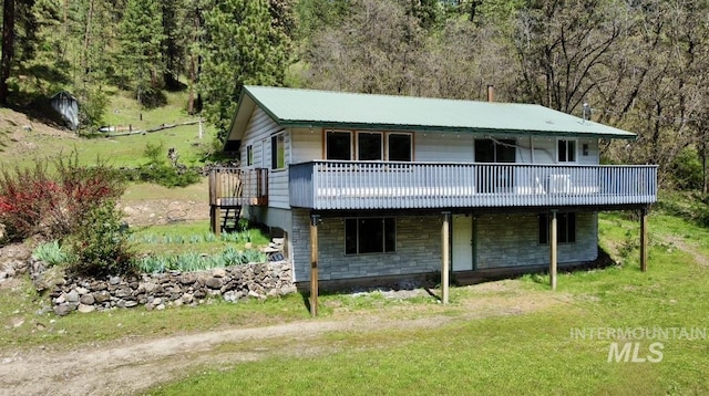 250 Hill Rd, Orofino, ID 83543 - view of front facade with stairs, a deck, a front yard, and a view of trees