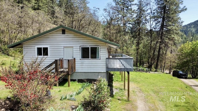 250 Hill Rd, Orofino, ID 83543 - view of home's exterior with a wooden deck, a yard, and a view of trees