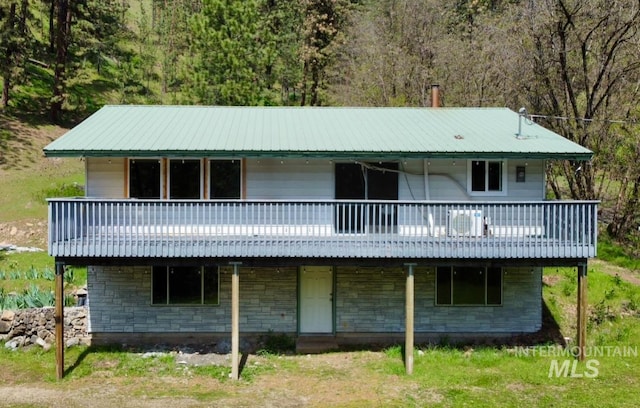 250 Hill Rd, Orofino, ID 83543 - back of house featuring a wooden deck, metal roof, and stone siding