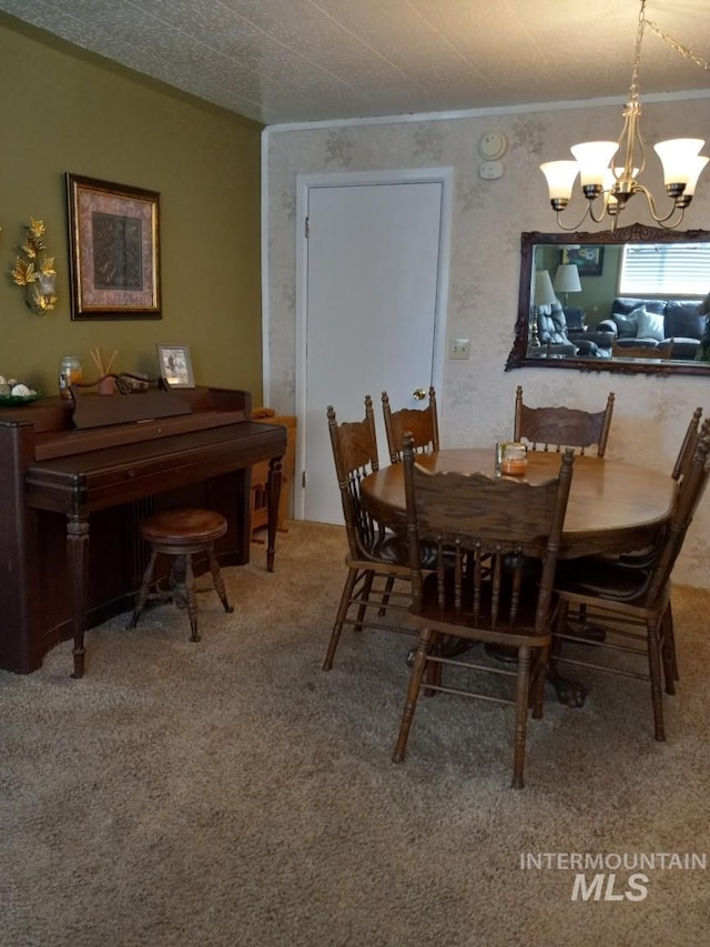 dining space featuring a notable chandelier, carpet, and ornamental molding