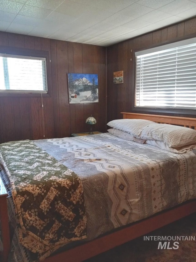 bedroom with wood walls