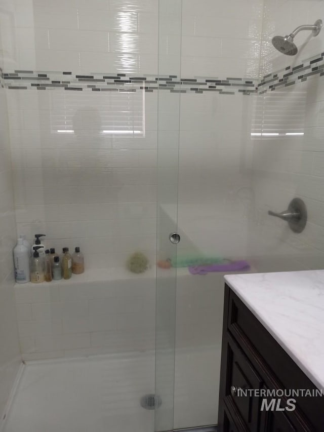 full bath featuring a stall shower and vanity