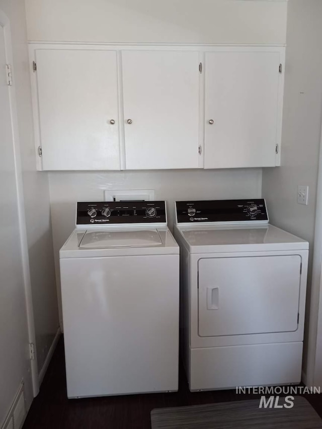 washroom with cabinet space, visible vents, and washing machine and dryer