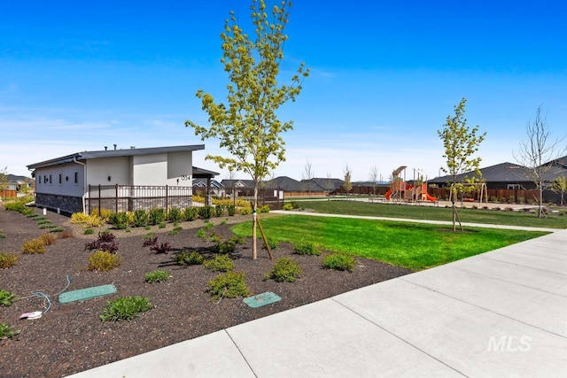 view of yard with playground community and fence