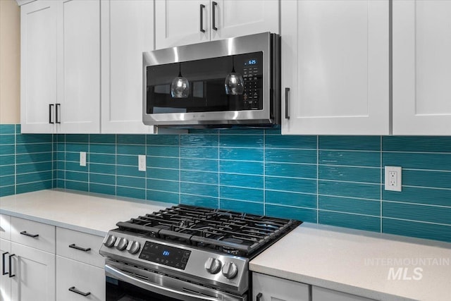 kitchen featuring white cabinets, backsplash, and stainless steel appliances