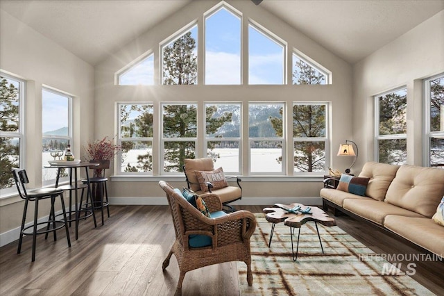 sunroom / solarium featuring lofted ceiling