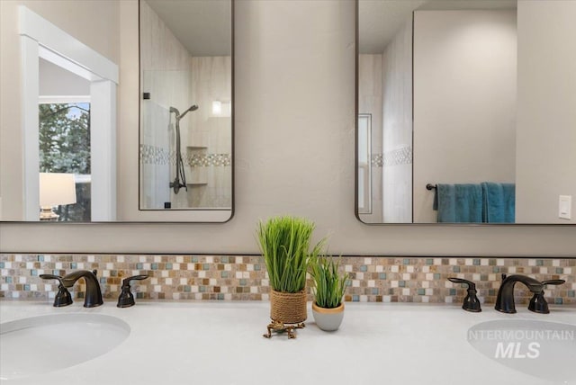 bathroom featuring backsplash, a shower, and vanity