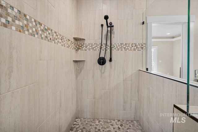 bathroom with a tile shower