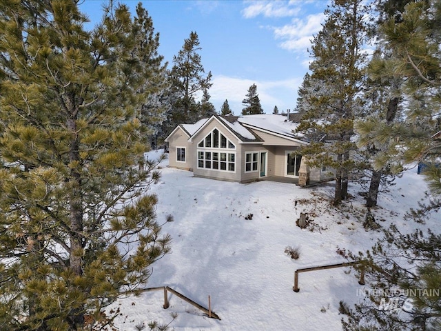 view of snow covered back of property