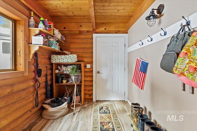 mudroom featuring beamed ceiling, wooden ceiling, wood finished floors, and log walls