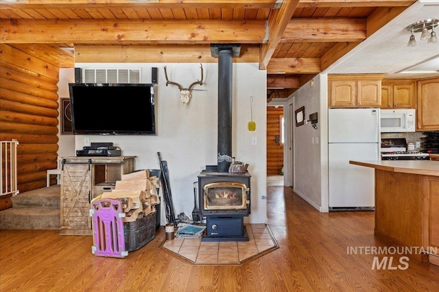 living room featuring a wood stove, light wood-style flooring, wood ceiling, and beam ceiling