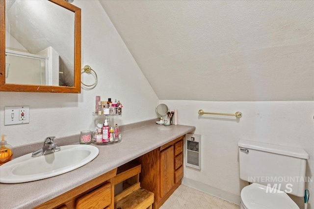 bathroom with a textured ceiling, lofted ceiling, toilet, vanity, and an enclosed shower