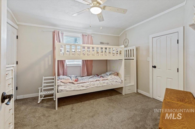 bedroom with baseboards, carpet flooring, a ceiling fan, and crown molding