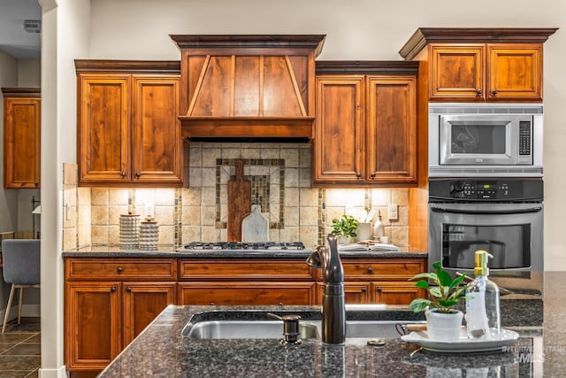 731 E Eaglewoods Ln, Eagle, ID 83616 - kitchen featuring appliances with stainless steel finishes, premium range hood, dark stone counters, and backsplash
