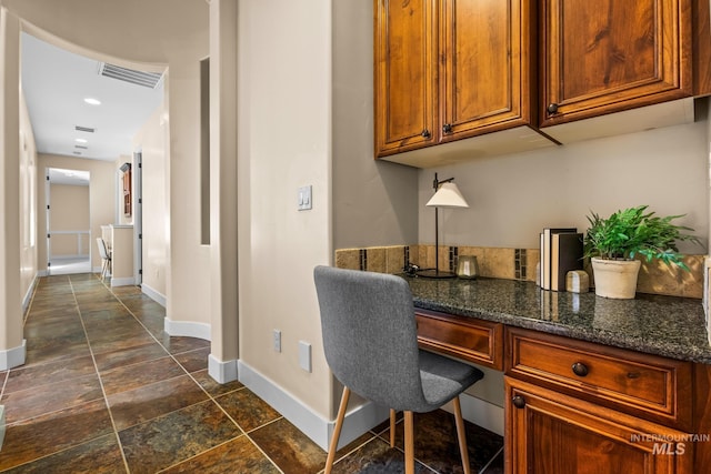 731 E Eaglewoods Ln, Eagle, ID 83616 - office space with built in study area and dark stone finish floors