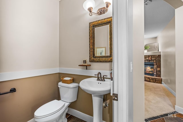 731 E Eaglewoods Ln, Eagle, ID 83616 - bathroom featuring toilet and a stone fireplace