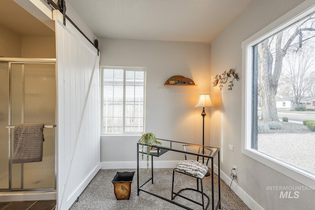 office with a barn door and baseboards