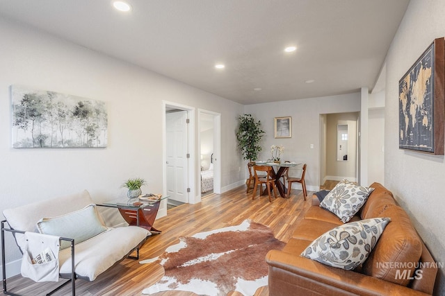 living area with recessed lighting, wood finished floors, and baseboards