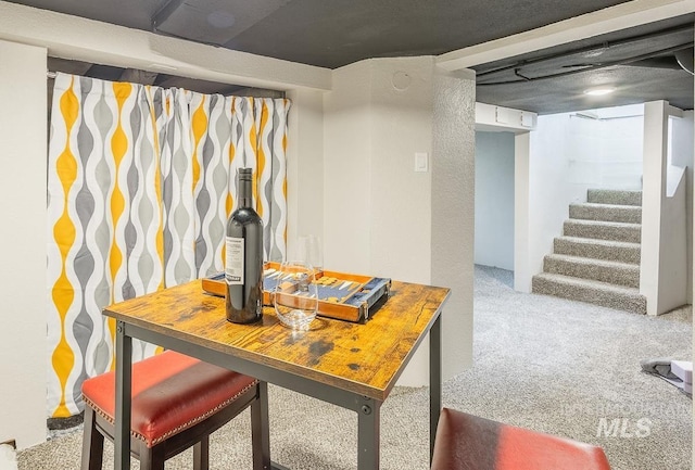 dining space featuring stairway and carpet