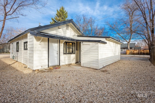 rear view of house featuring fence