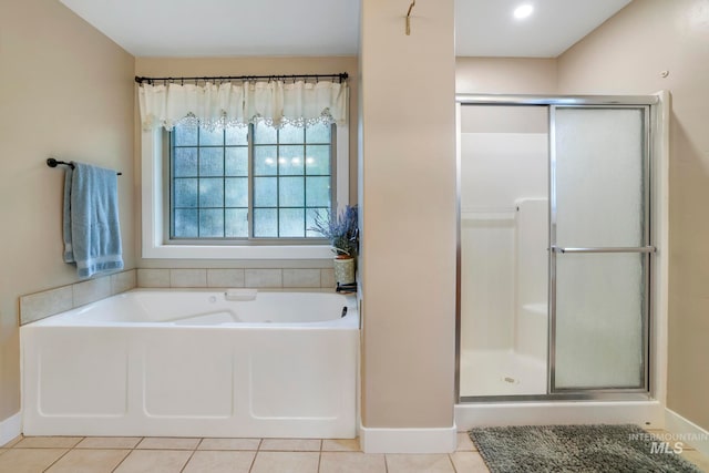 bathroom featuring independent shower and bath and tile patterned flooring