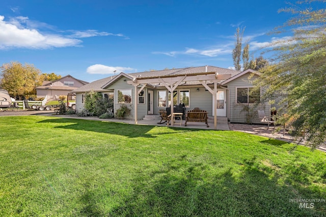 rear view of property with a patio area and a lawn