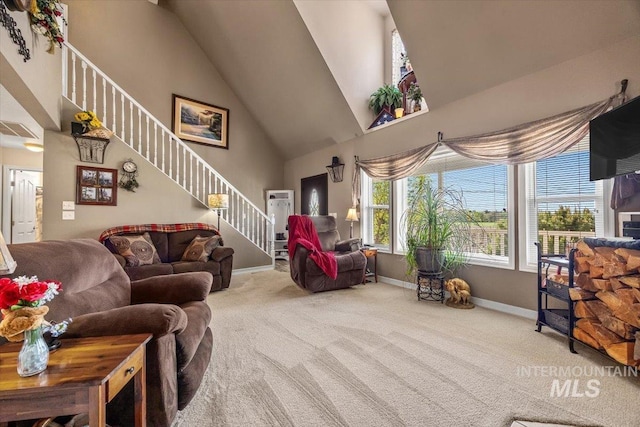carpeted living area featuring baseboards, high vaulted ceiling, and stairway