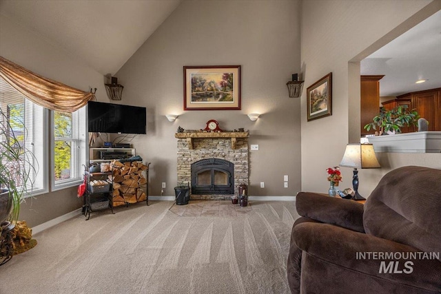 living area featuring high vaulted ceiling, baseboards, carpet, and a stone fireplace