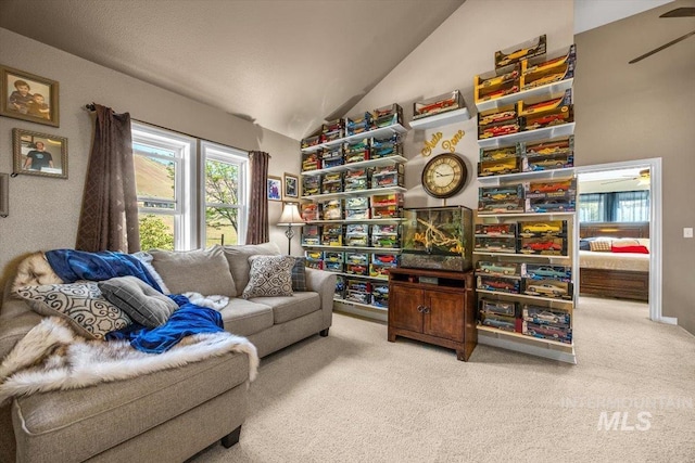 sitting room featuring light colored carpet, ceiling fan, and lofted ceiling
