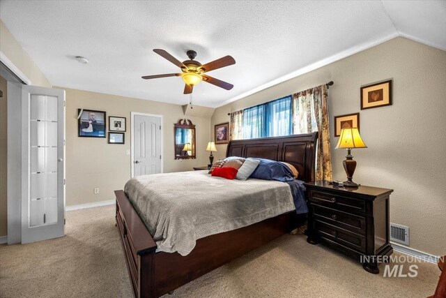 bedroom with carpet flooring, ceiling fan, baseboards, lofted ceiling, and visible vents