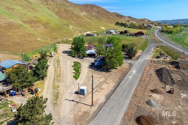 birds eye view of property with a mountain view and a rural view