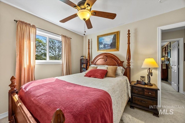 bedroom featuring a ceiling fan, baseboards, and light carpet