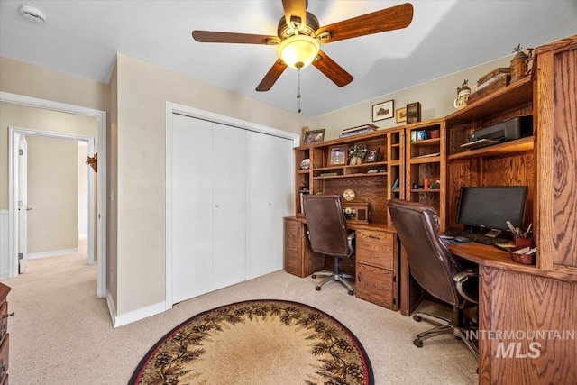 office space with ceiling fan and light colored carpet