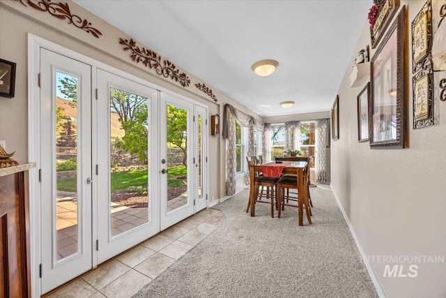 sunroom with plenty of natural light and french doors