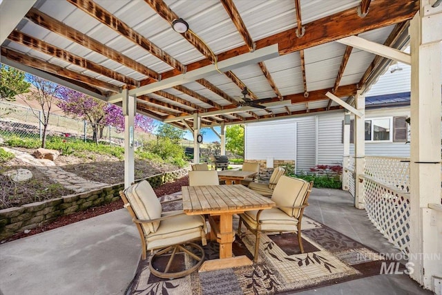 view of patio with fence and outdoor dining space