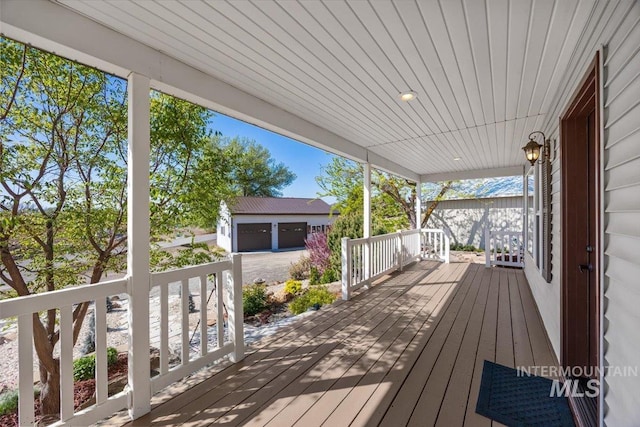 deck featuring an outdoor structure and a porch