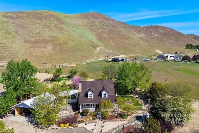birds eye view of property with a mountain view and a rural view