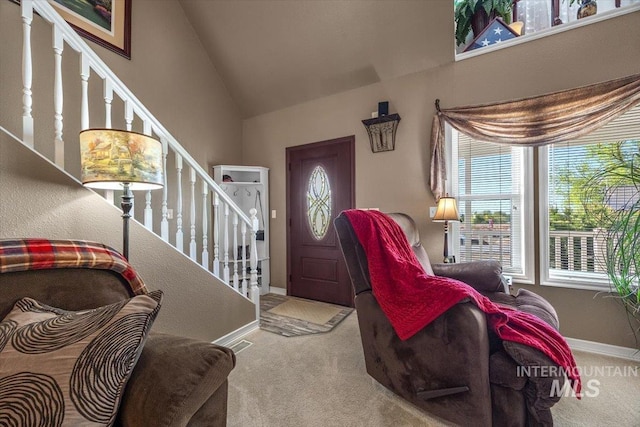 interior space with baseboards, lofted ceiling, and stairway