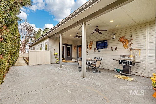 view of patio with a ceiling fan, outdoor dining area, area for grilling, and fence