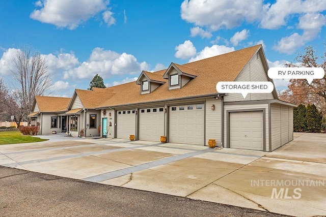 view of property with driveway, roof with shingles, and a garage