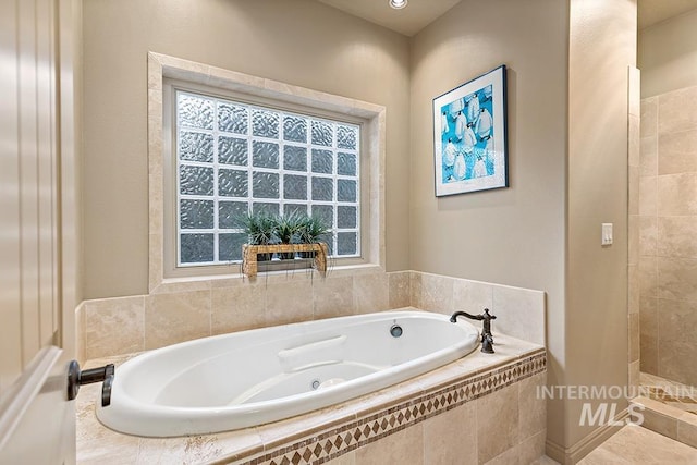 bathroom with a bath and a tile shower