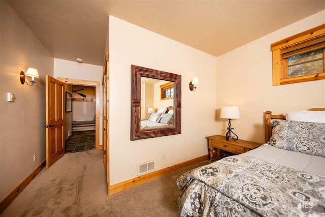 carpeted bedroom featuring visible vents and baseboards
