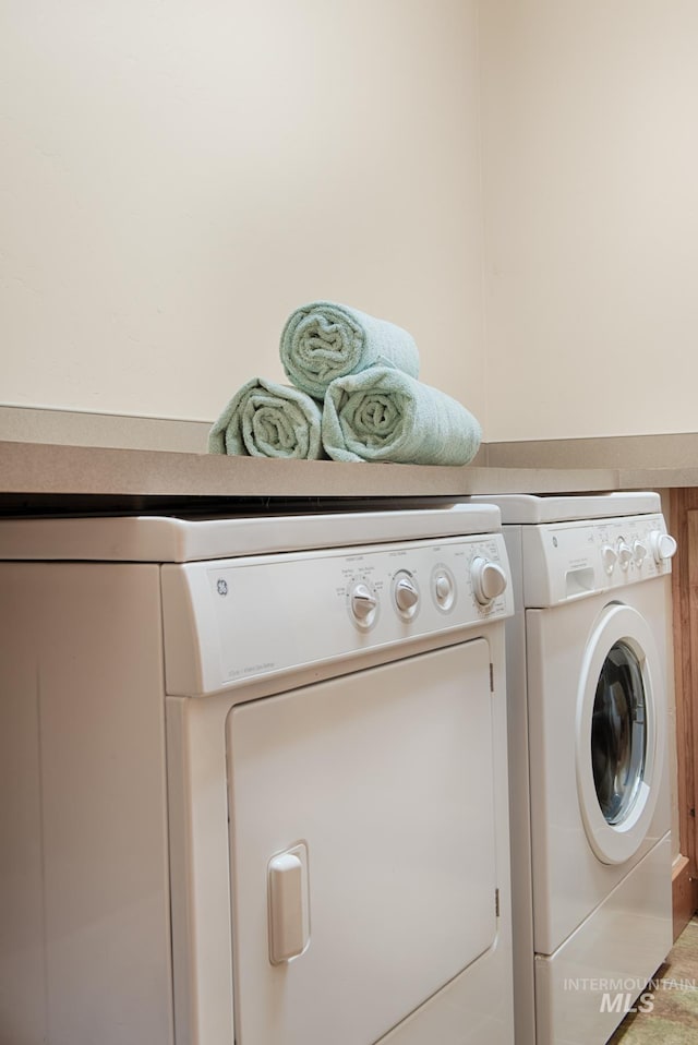 clothes washing area with laundry area and washing machine and dryer