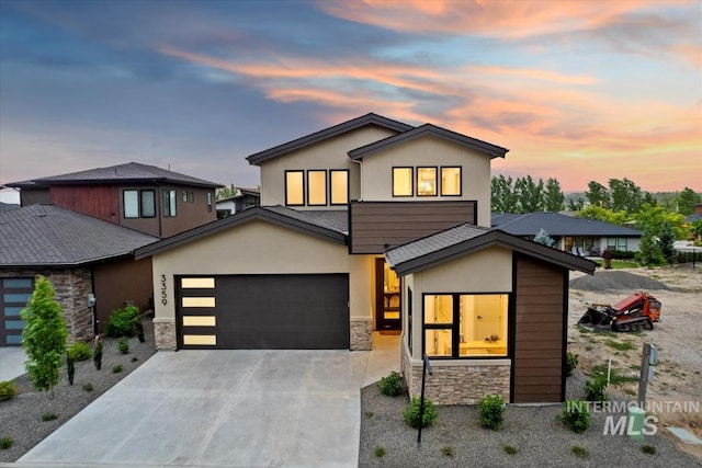 3359 E Warm Springs Ave, Boise, ID 83716 - contemporary home with stone siding, stucco siding, concrete driveway, and a garage
