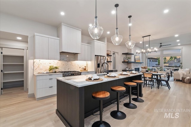 3359 E Warm Springs Ave, Boise, ID 83716 - kitchen with modern cabinets, light wood finished floors, white cabinetry, tasteful backsplash, and recessed lighting