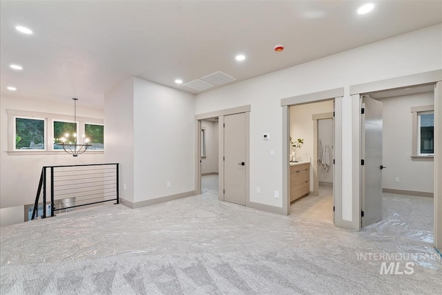 3359 E Warm Springs Ave, Boise, ID 83716 - unfurnished living room with a chandelier, recessed lighting, and light colored carpet