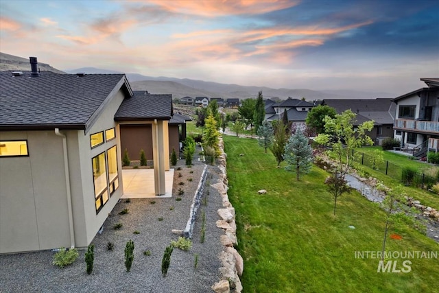 3359 E Warm Springs Ave, Boise, ID 83716 - yard at dusk featuring a patio, a mountain view, and a residential view