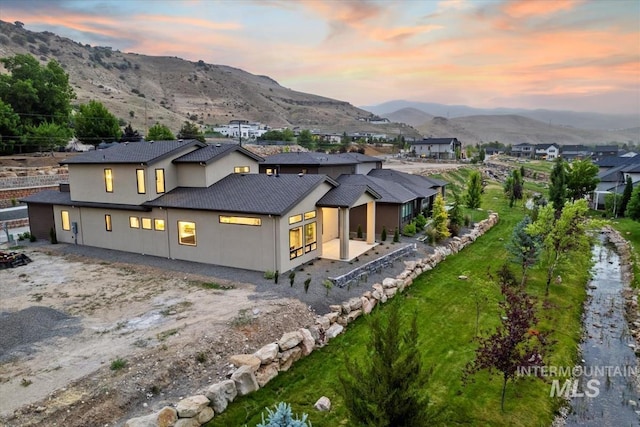 3359 E Warm Springs Ave, Boise, ID 83716 - back of house featuring a mountain view and stucco siding